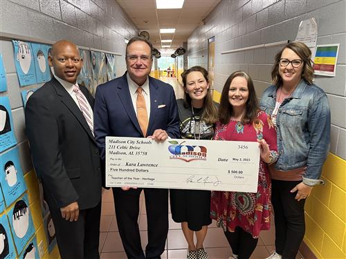 Kara Lawrence with oversized check and prize patrol